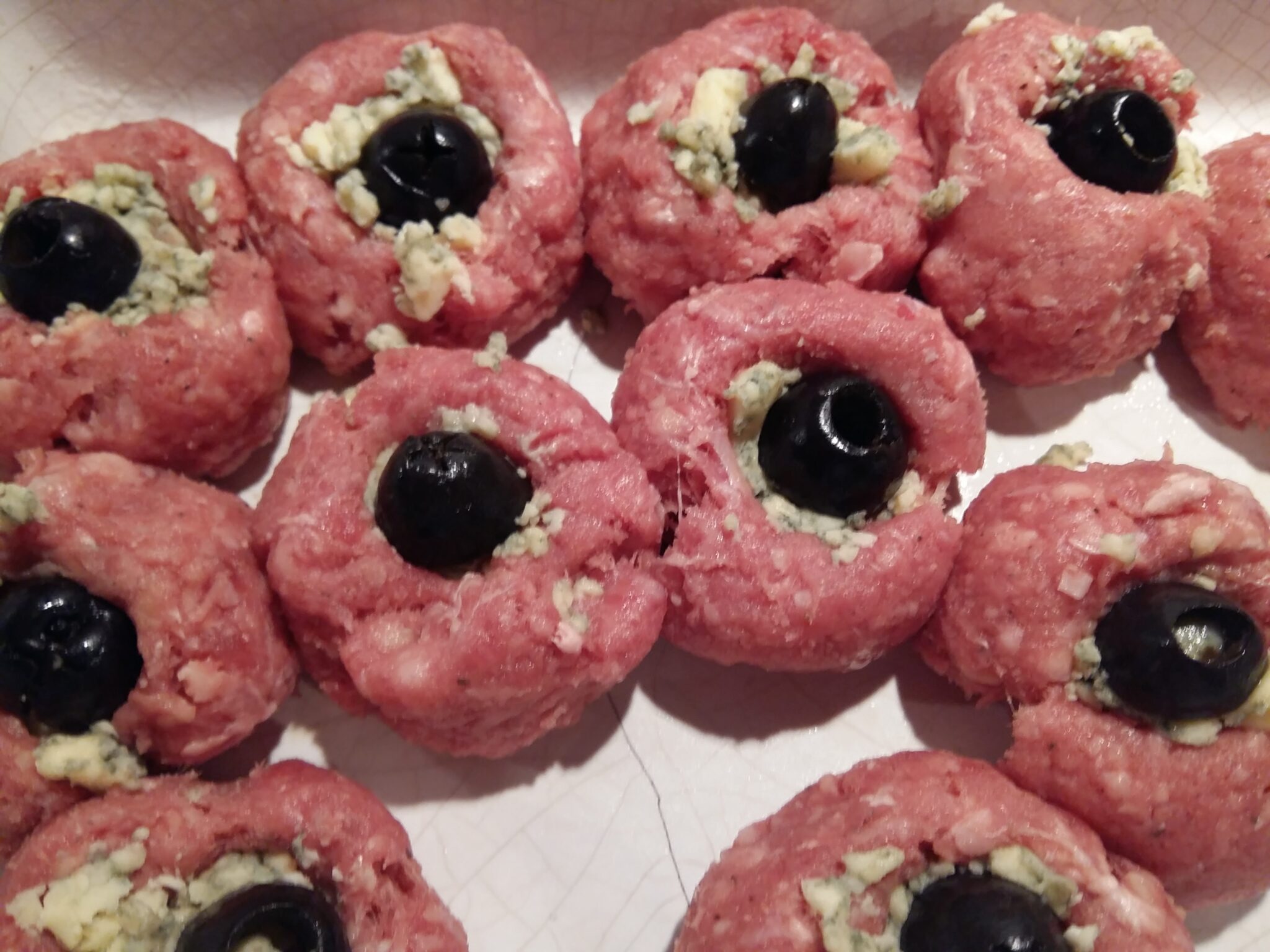 Meatballs stuffed with cheese and olives